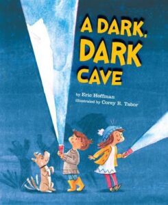 The cover of the book A Dark, Dark Cave. The illustration is of two children and a dog against a blue background. They are holding flashlights and casting shadows on the background.
